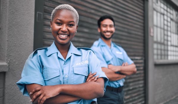 Team, security guard or safety officer portrait on the street for protection, patrol or watch. Law enforcement, smile and duty with a crime prevention unit man and woman in uniform in the city.